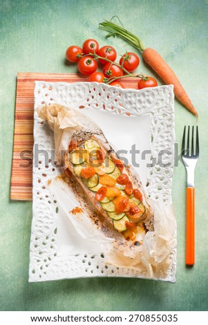 wrapped salmon with zucchnis tomatoes and carrots