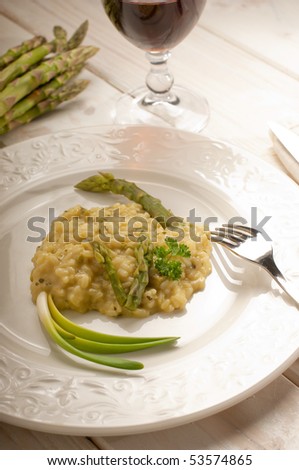 asparagus rice with fork and red wine