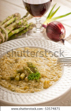 asparagus rice with fork and red wine