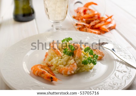 rice with shrimp and glass of white wine