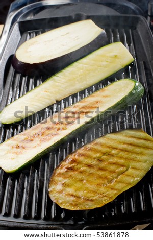 zucchinis and eggplant cooking on grill