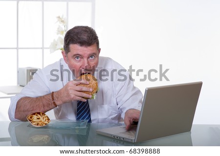 man at office  eat unhealthy fast food