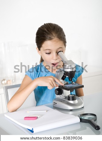 astonished little girl  study with microscope