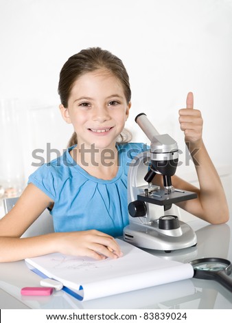 little girl  study with microscope