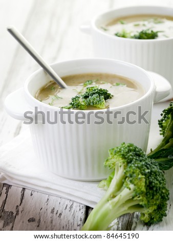 broccoli soup on bowl over wood background