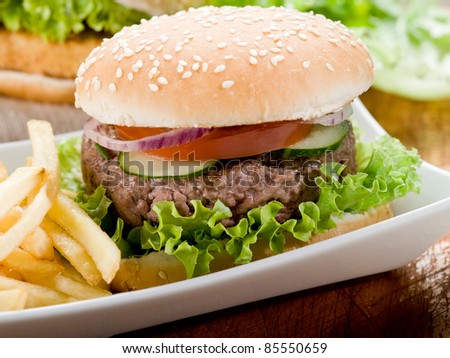 sandwich with hamburger and fried potatoes