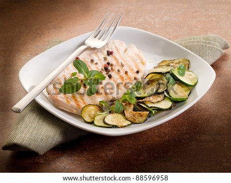chest of grilled chicken with zucchinis and mint leaf