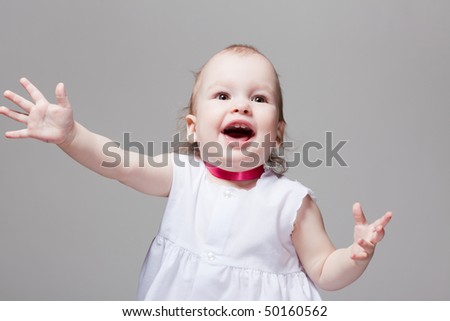 Portrait of excited cute baby with open mouth and hands