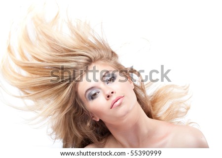 Portrait of a beautiful young woman with her blonde blowing hair mid movement