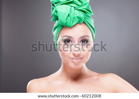 Happy smiling pin-up woman with green scarf on head and pink-green makeup
