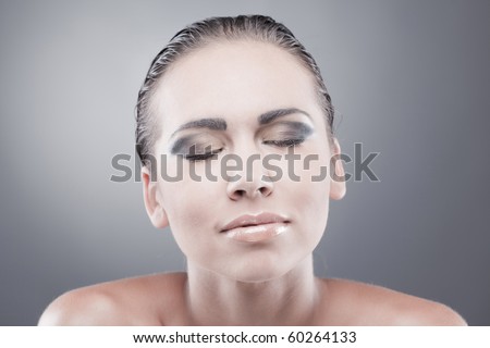 Satisfied dreaming brunette woman with closed eyes smiling