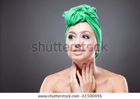 Surprised excited pin-up woman holding neck with hands