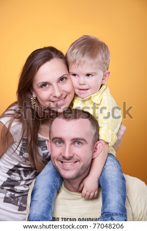 Young parents with little son on father\'s shoulders
