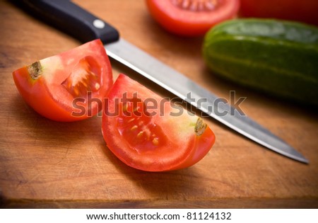Fresh vegetables on wooden board with knife