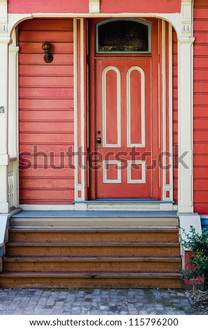 Traditional red painted wooden door and porch