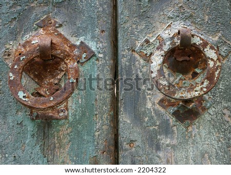 Grunge painted door details with rusty metal handle