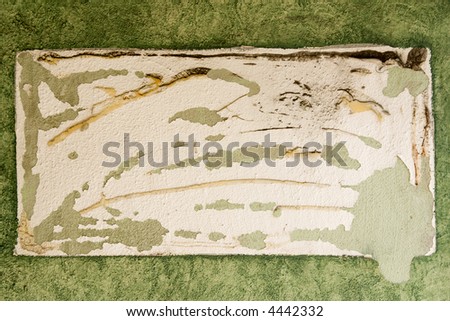 Grunge stucco wall with trace of removed sign - background and texture