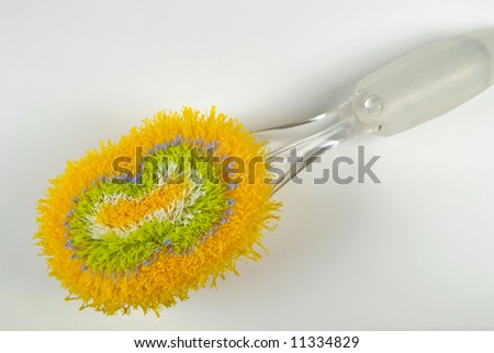 Colorful brush for dishes - closeup on white background