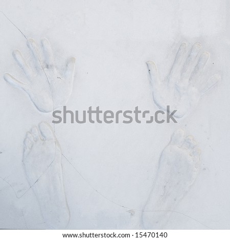 Plaster hands and feet relief on wall