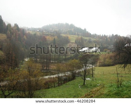 Rural landscape. Village in the East Carpathian mountains. Foggy day in the mountainous village.
