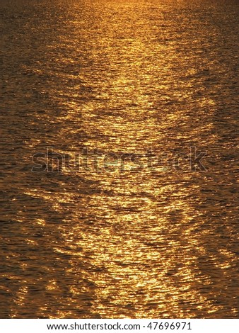 Sunny reflection. Reflection of the sundown in the sea. Solar patches of light on water. Solar path.