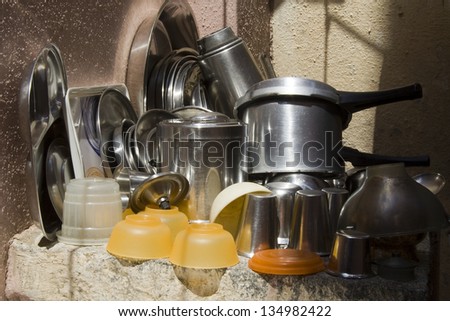 Washed kitchen utensils and crockery stacked for water drain-out