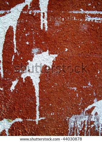 scratched red wall background with white splatters