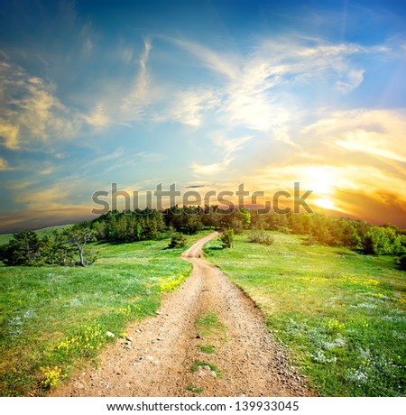 Country road in the mountains at sunset
