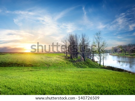 Spring landscape with the river and the sun