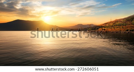 Calm sea and mountains at the beautiful sunset