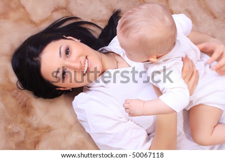 Little baby and mother on the floor