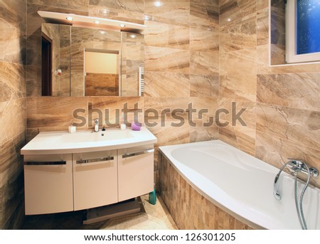 Master bathroom in luxury home with bath and furniture