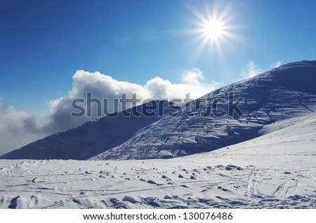 Winter mountain landscape with sun