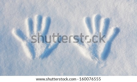 Winter theme: two handprints in the snow.