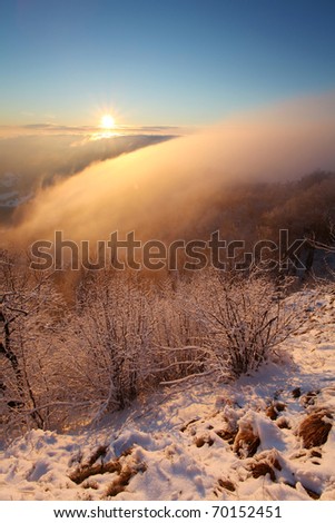 Winter sunset over the clouds