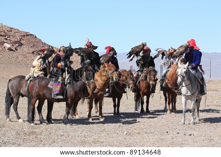 MONGOLIA - 25 JULY: Senior Mongolians horsemen in traditional clothing with golden eagles during the festival of name \