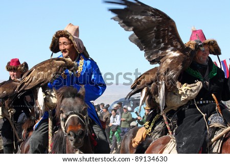 MONGOLIA - 25 JULY: The senior Mongolians horsemen in traditional clothing with golden eagles during the festival of name \