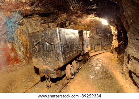 Underground train in mine, carts in gold, silver and copper mine.