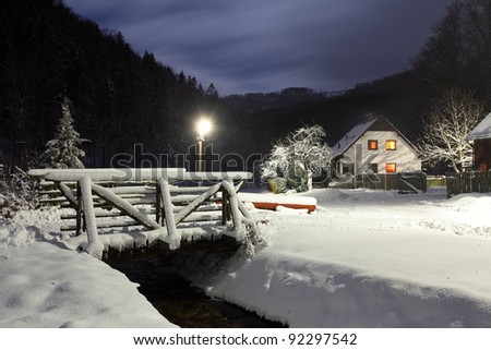 Wintry landscape with chalet.