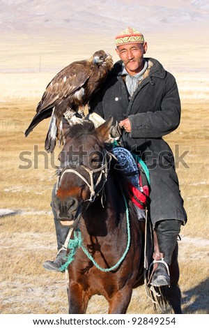 MONGOLIA - 25 JULY: The senior Mongolian horseman in traditional clothing with golden eagles during the festival of name \