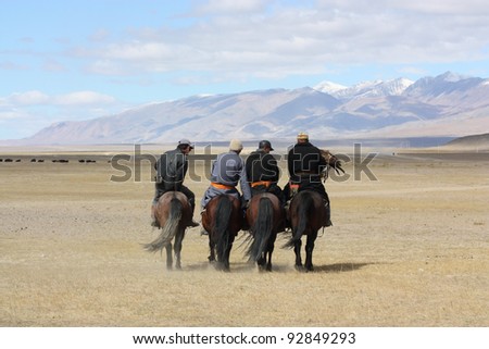 MONGOLIA - 25 JULY: Senior Mongolians horsemen in traditional clothing with golden eagles during the festival of name \