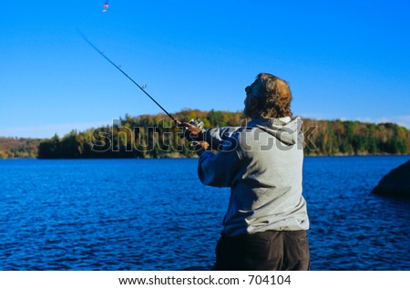 A man casting out his fishing line.