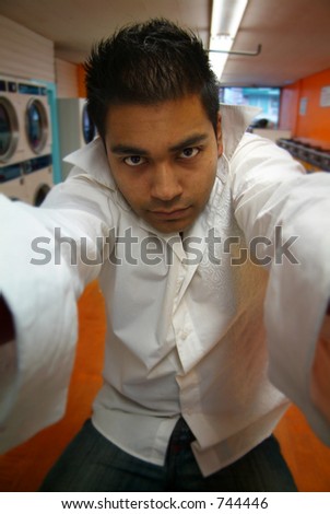 A man grabbing the camera at a local laundromat.