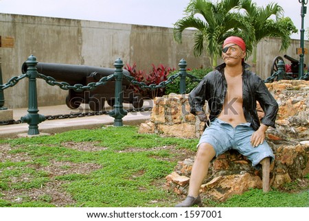 stock-photo-a-pirate-with-a-wooden-leg-sits-among-ruins-and-cannons-sculpture-1597001.jpg