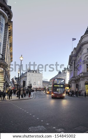 LONDON, UNTED KINGDOM - APRIL 15: Buses and people on the street just next to Piccadilly Circus on April 15, 2013 in London UK. Piccadilly Circus is the most important square in the city of London