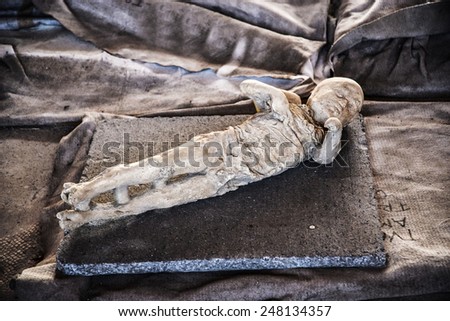 child\'s body inside the Roman archeologic ruins of the lost city of Pompeii,  Italy