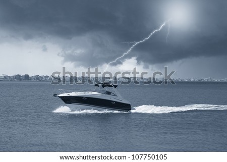 boat along the coast with storm over the town