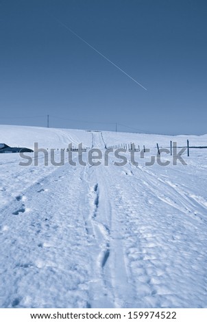 country road with snow under starry sky