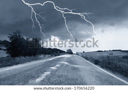 countryroad with lightning in the sky