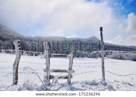 fence covered with ice on the hill